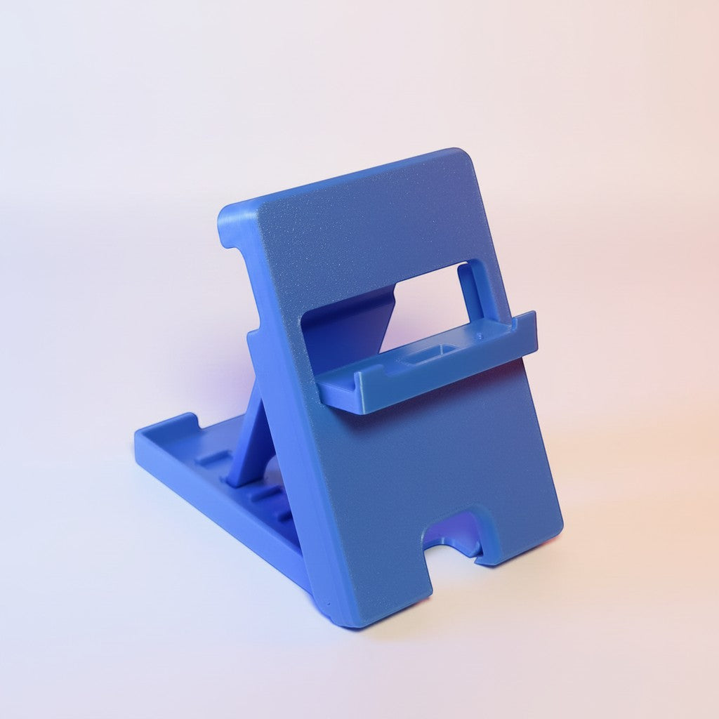 MJR Crafted blue foldable 3D-printed Nintendo Switch stand with adjustable angle and cable slot.