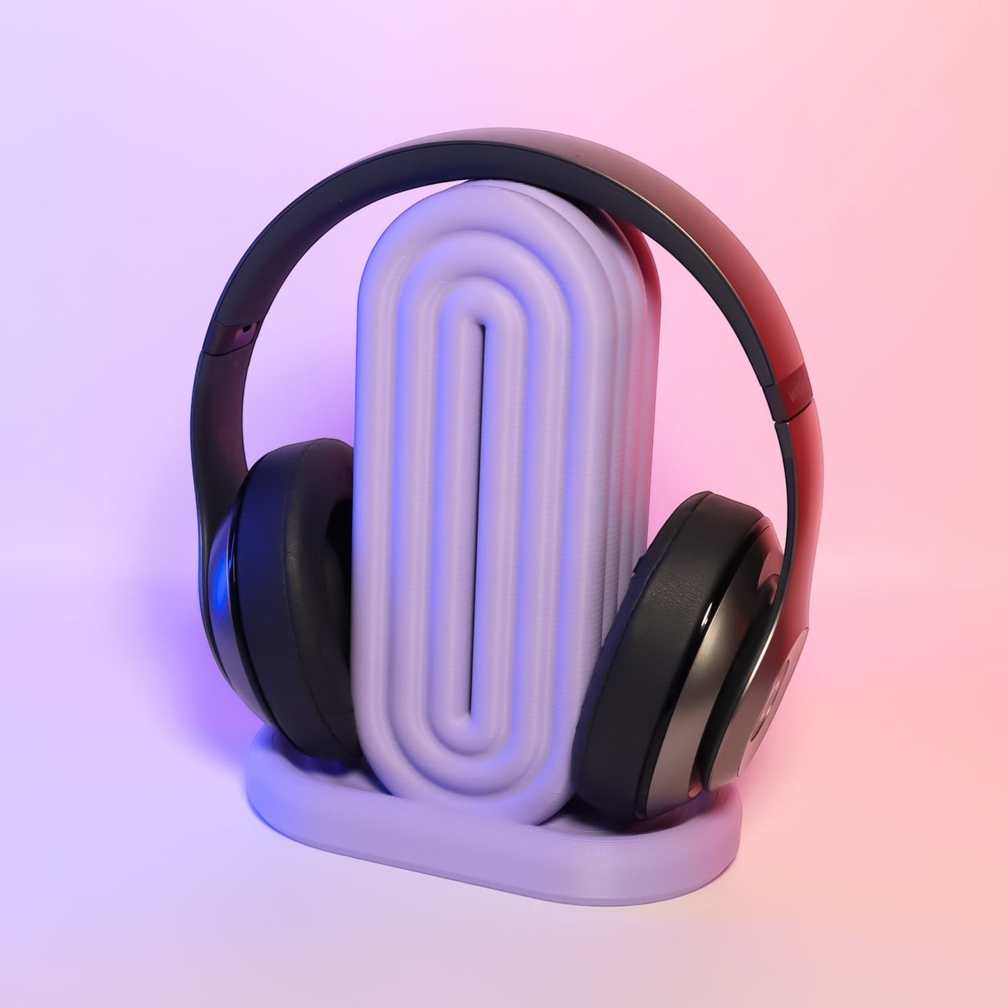 MJR Crafted rainbow headphone holder in pastel purple with ribbed design, holding black headphones.