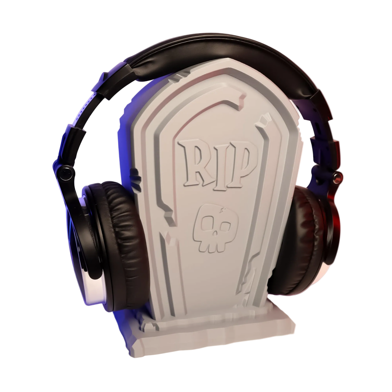Headphones on a gravestone-shaped stand with 'RIP' design against a gradient background