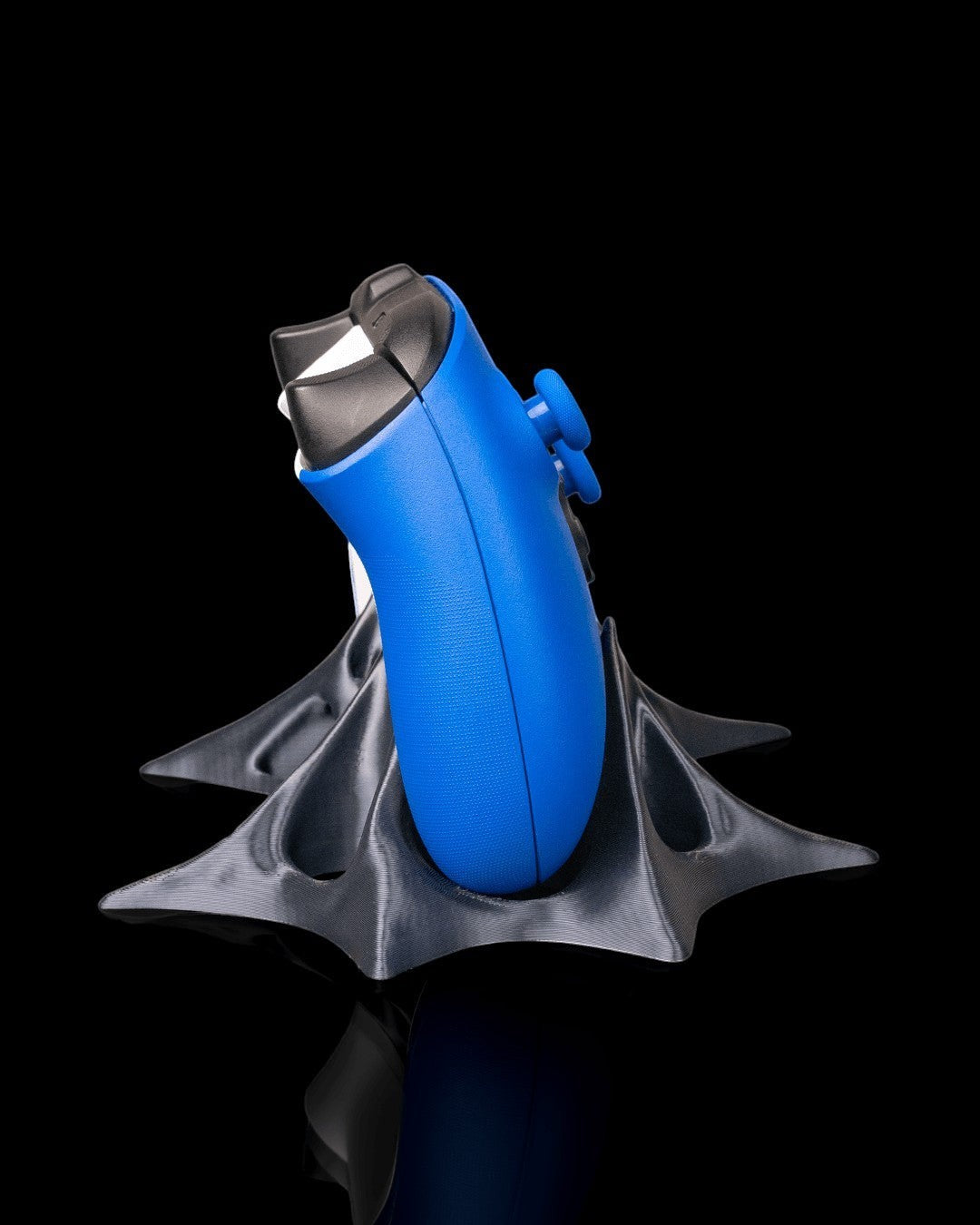 MJR Crafted blue gaming controller on a sculptural, dark grey PLA filament stand with a futuristic design.