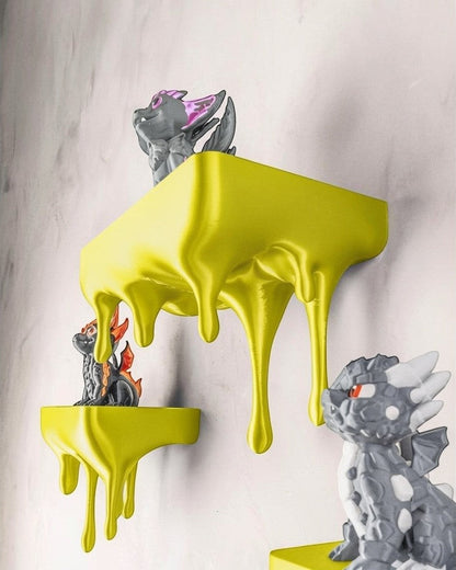 MJR Crafted blue 3D printed melting shelf with a unique dripping design, holding dragon figurines.