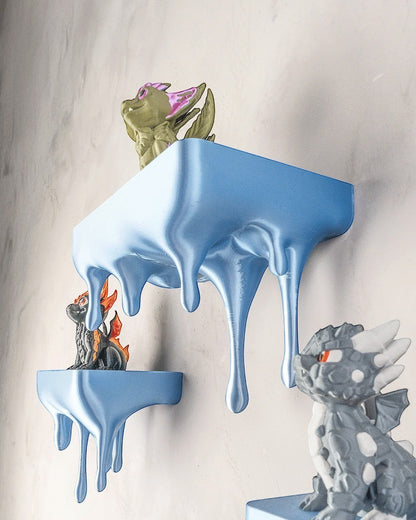 MJR Crafted blue 3D printed melting shelf with dripping effect, holding dragon figurines.