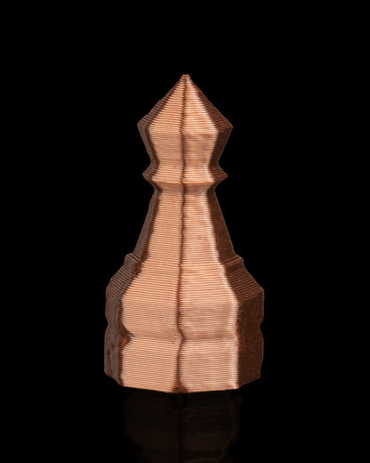 MJR Crafted copper-colored 3D printed chess piece with a pointed top and layered texture on a black background.