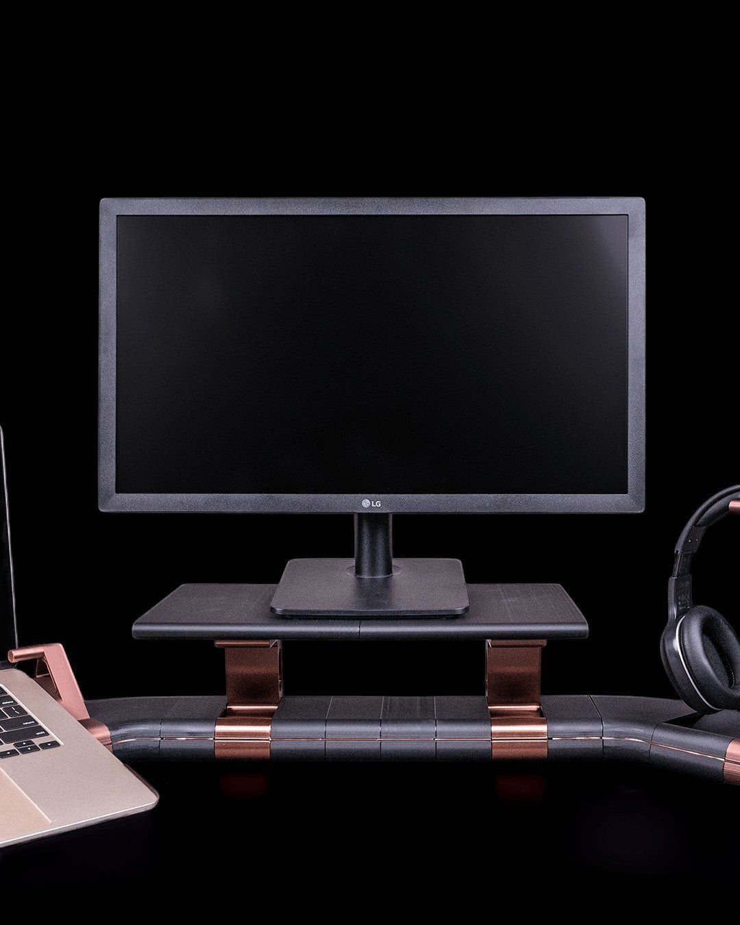 MJR Crafted Focus Desk Hub modular monitor stand in gray with bronze accents holding a computer monitor and laptop.