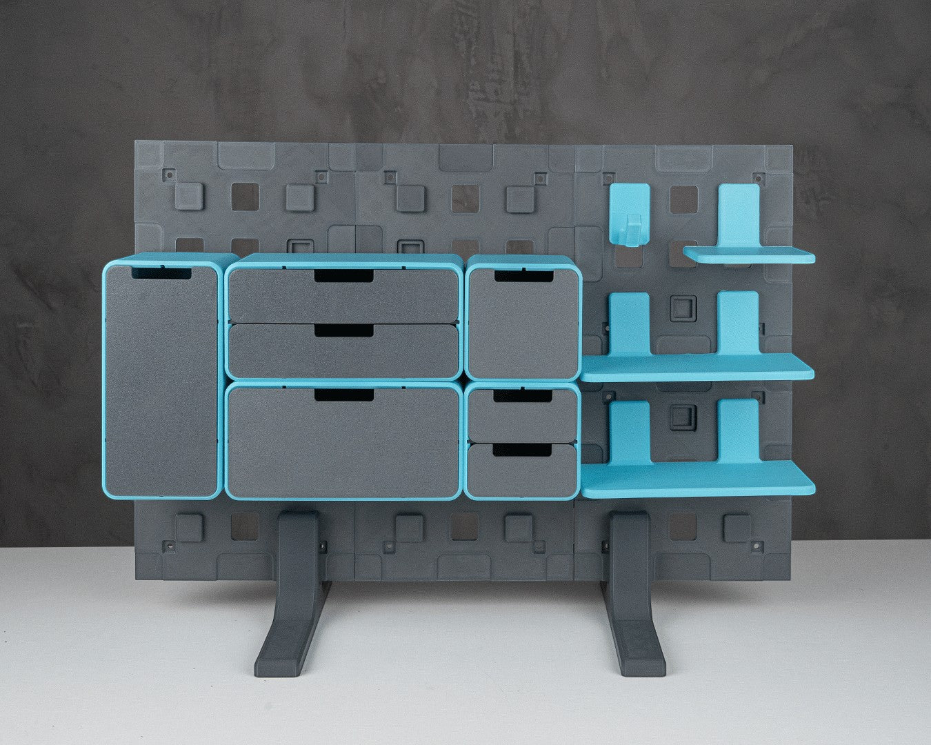 MJR Crafted modular organizer system with grey drawers and blue shelves and accents, standing on grey legs.