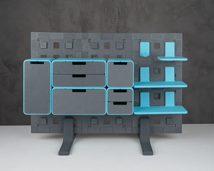 MJR Crafted modular organizer system with grey drawers and blue shelves and accents, standing on grey legs.