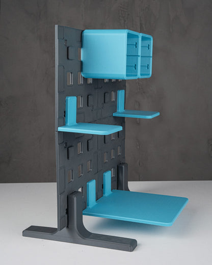 MJR Crafted modular organizer system in grey and bright blue, featuring shelves, drawers, and a pegboard-style back panel.