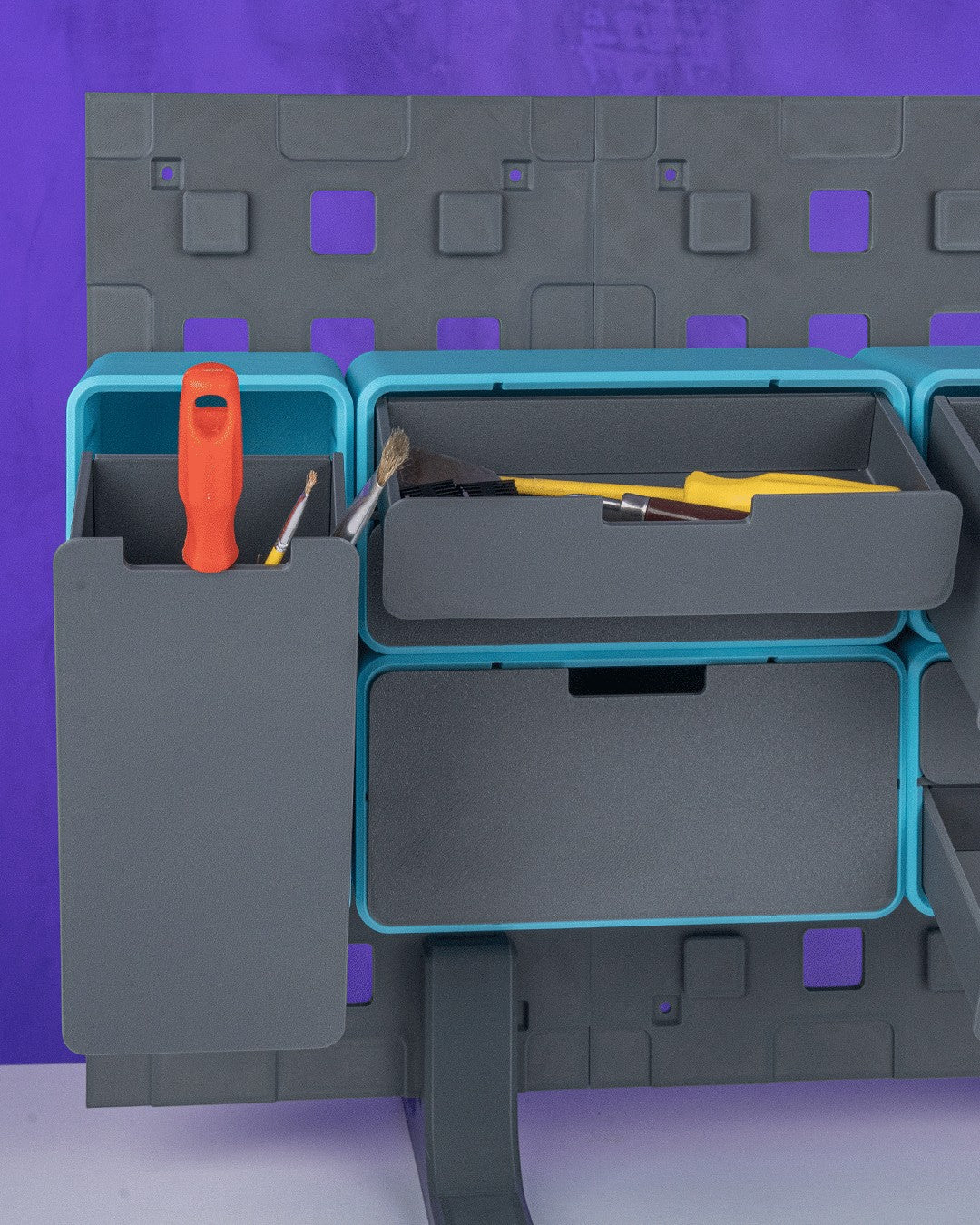 MJR Crafted modular organizer system with grey and teal components holding tools and drawers.