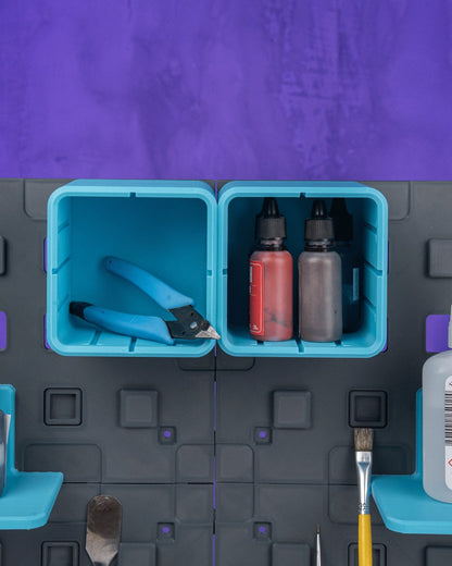 MJR Crafted modular organizer system with teal bins holding tools and bottles. Grey panels with purple accents.