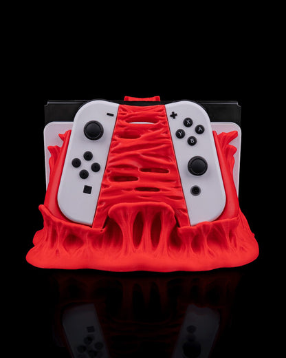 MJR Crafted red 3D printed dock cover and controller holder for Nintendo Switch, featuring a monster design.