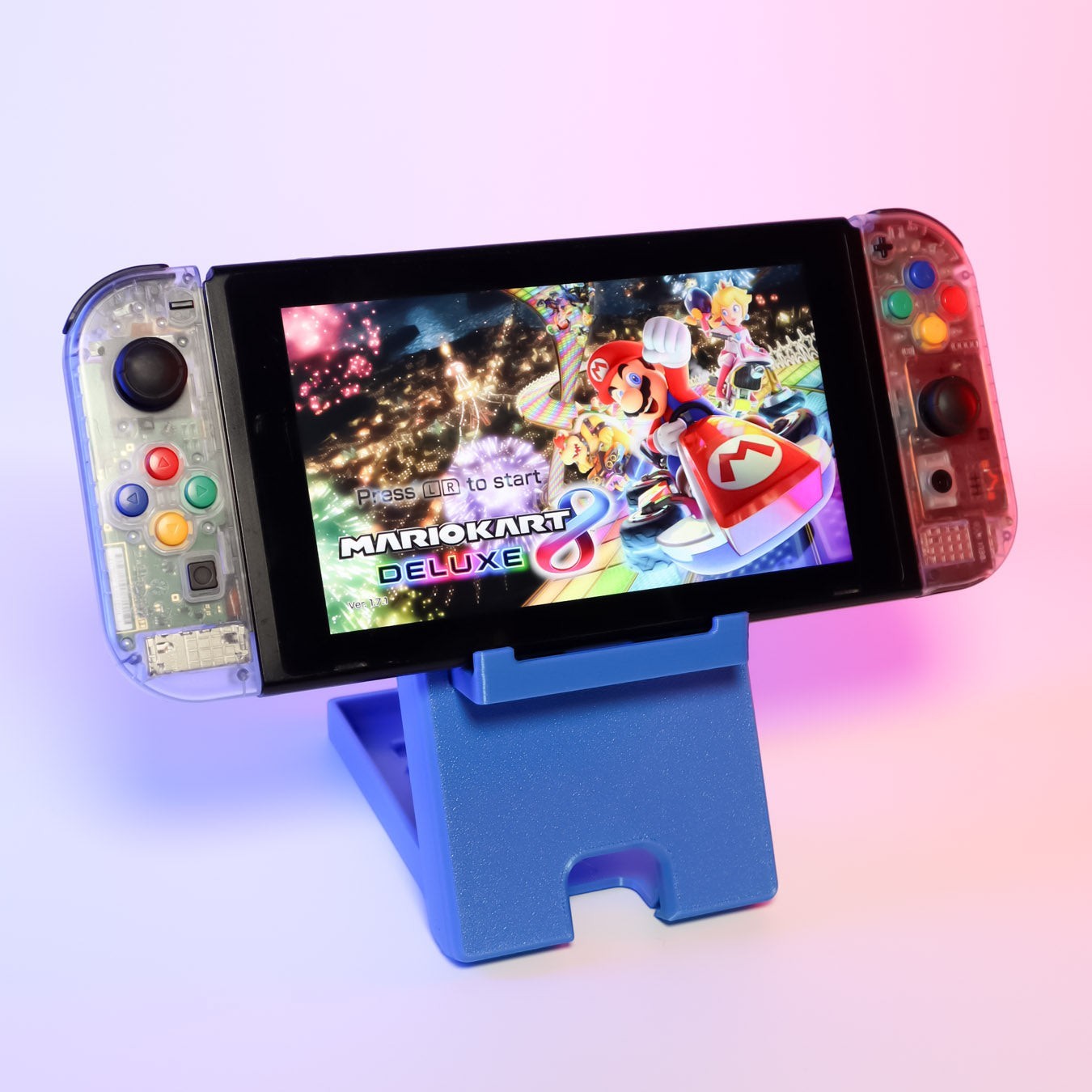 MJR Crafted blue 3D-printed foldable Nintendo Switch stand holding a Switch playing Mario Kart 8 Deluxe.