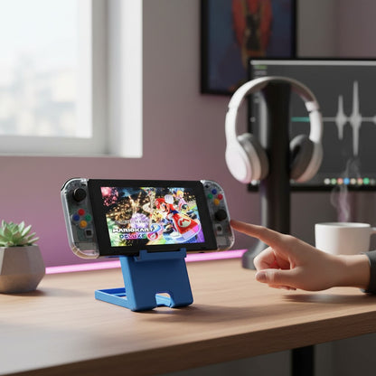 MJR Crafted blue 3D-printed foldable Nintendo Switch stand with adjustable angle and cable slot, holding a Switch console.