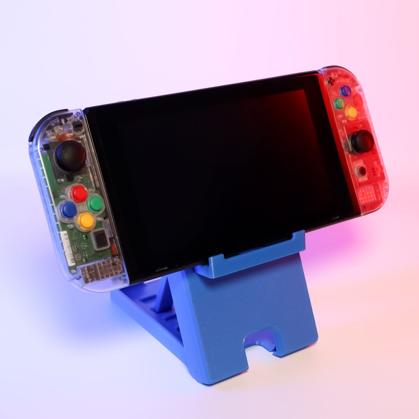 MJR Crafted blue 3D-printed foldable Nintendo Switch stand with adjustable angle and cable slot.