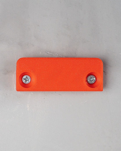 MJR Crafted orange 3D printed wall mount shelf with two screws visible.