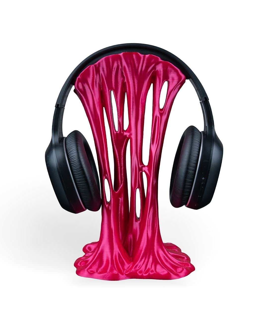 MJR Crafted pink metallic headphone stand with a dripping, melted effect, holding black over-ear headphones.