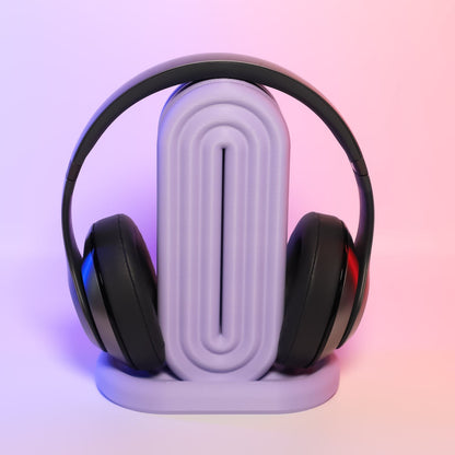 MJR Crafted rainbow headphone holder in lavender, featuring a unique ribbed design and a sleek base. Holds black headphones.