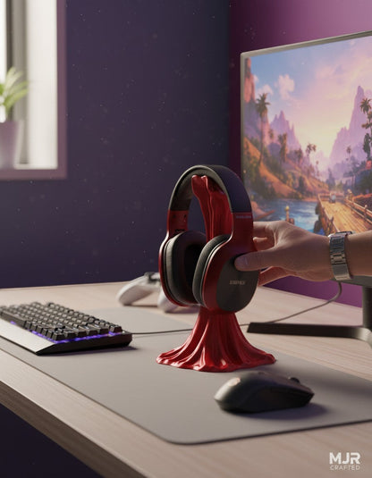 MJR Crafted red drumstick-inspired headphone stand holding wireless headphones on a modern desk setup