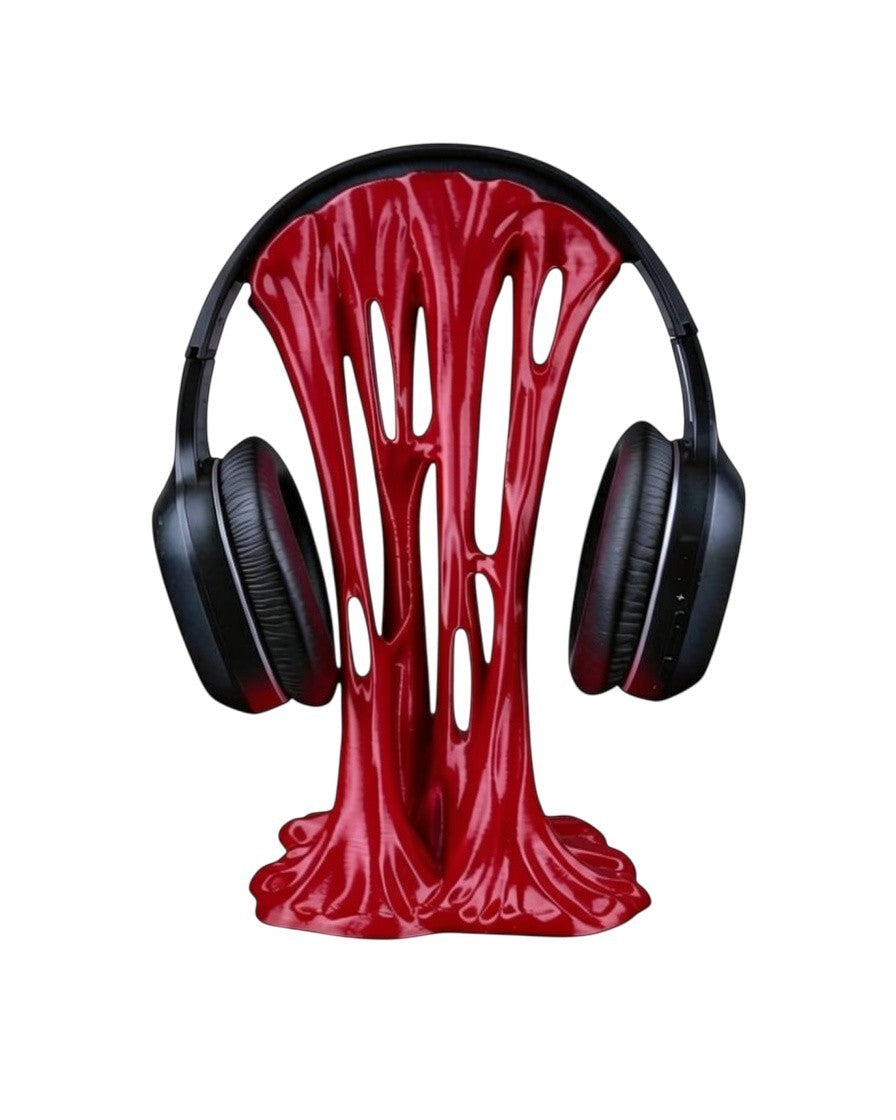 MJR Crafted red sticky-style headphone stand with a unique melted design holding black over-ear headphones.