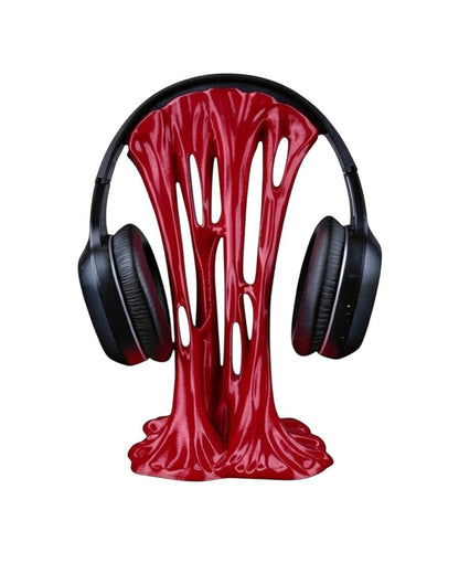 MJR Crafted red sticky-style headphone stand with a unique melted design holding black over-ear headphones.
