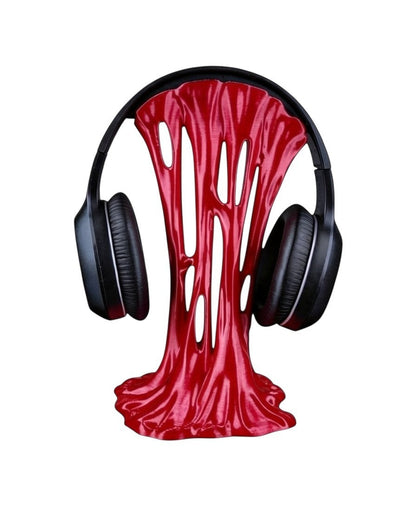 MJR Crafted red sticky-style headphone stand with a unique melting design holding black over-ear headphones.