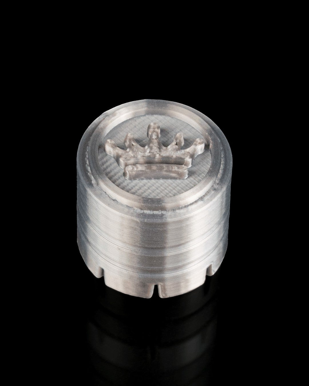 MJR Crafted silver 3D printed cylindrical herb grinder with crown emblem on top and serrated edge.
