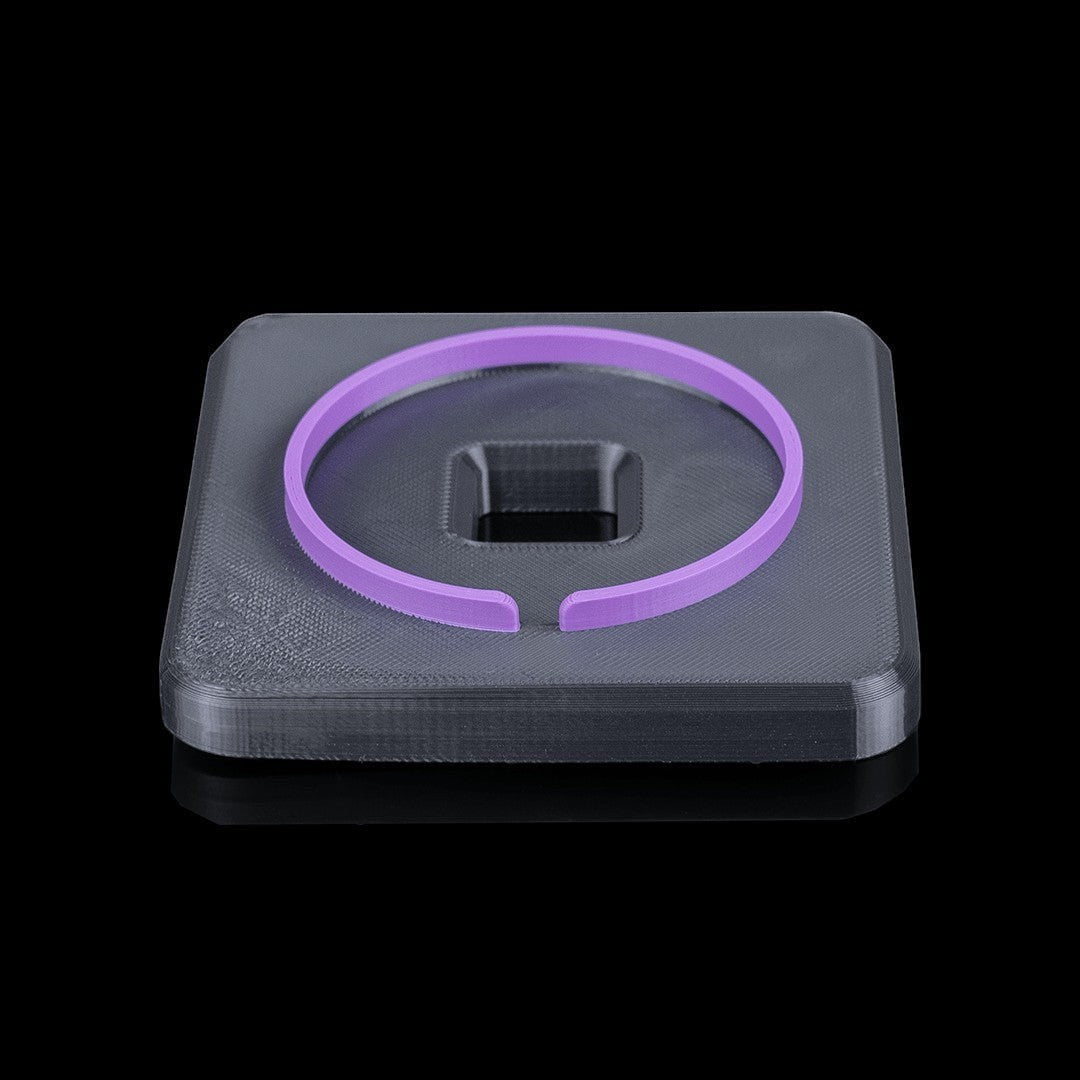 MJR Crafted modular desk organizer base in dark grey with a purple ring accessory on top.