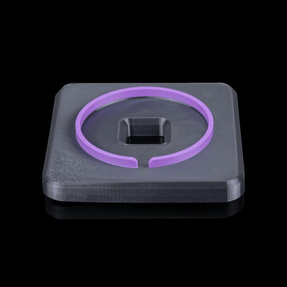 MJR Crafted modular desk organizer base in dark grey with a purple ring accessory on top.