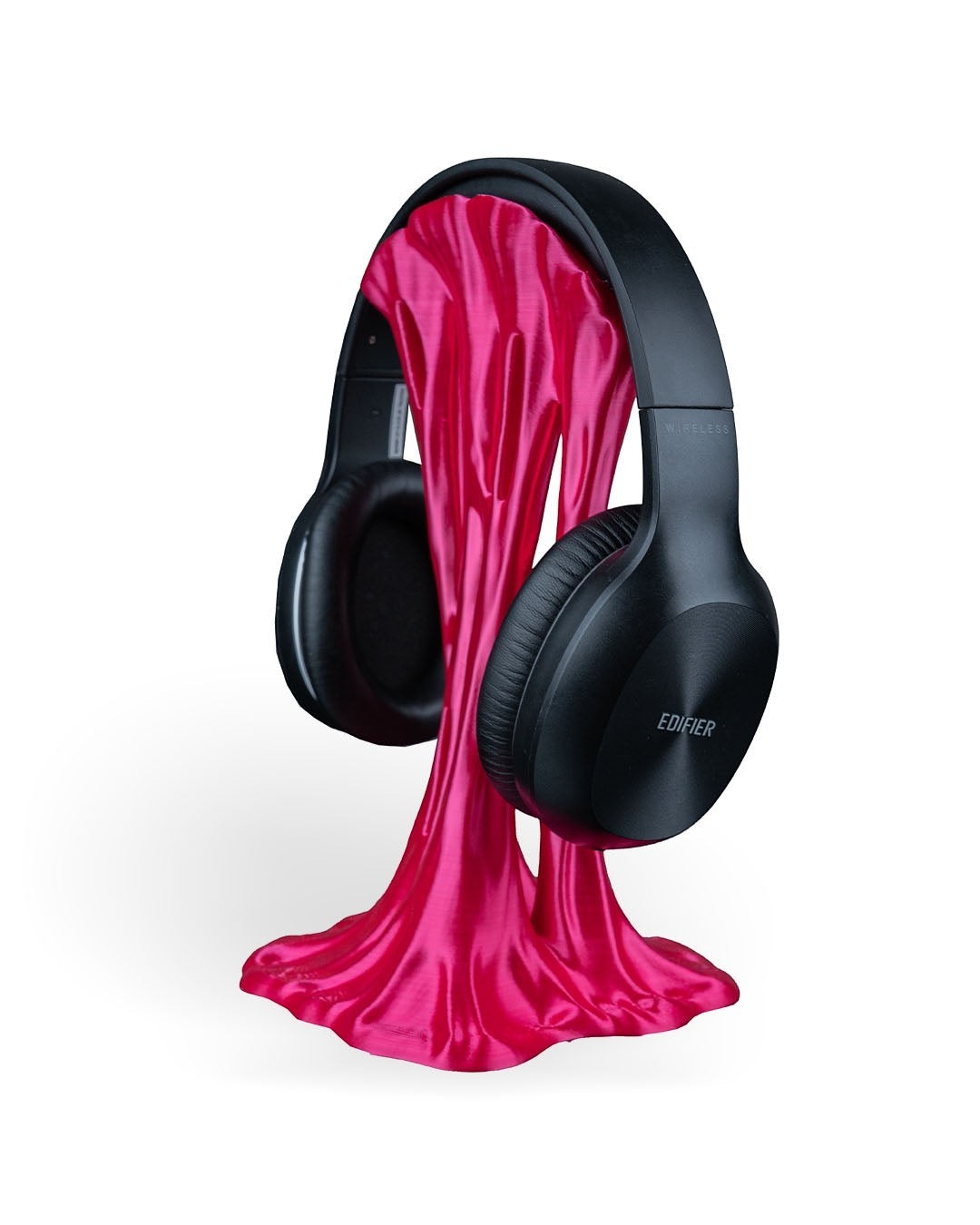 MJR Crafted pink headphone stand with a dripping effect holding black wireless headphones.