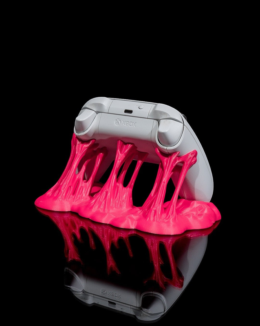 MJR Crafted pink slime controller stand holding a white Xbox controller. Unique gaming accessory.