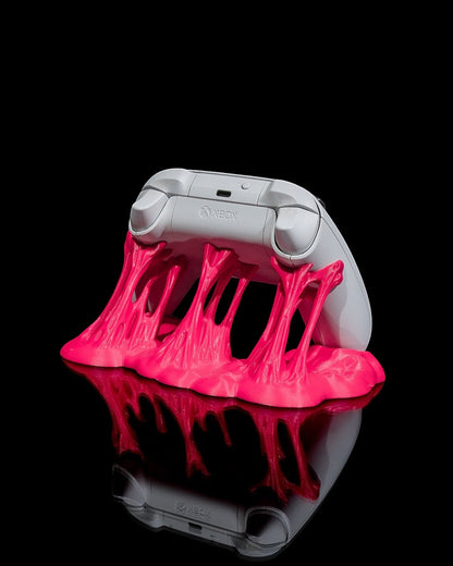 MJR Crafted pink slime controller stand holding a white Xbox controller. Unique gaming accessory.