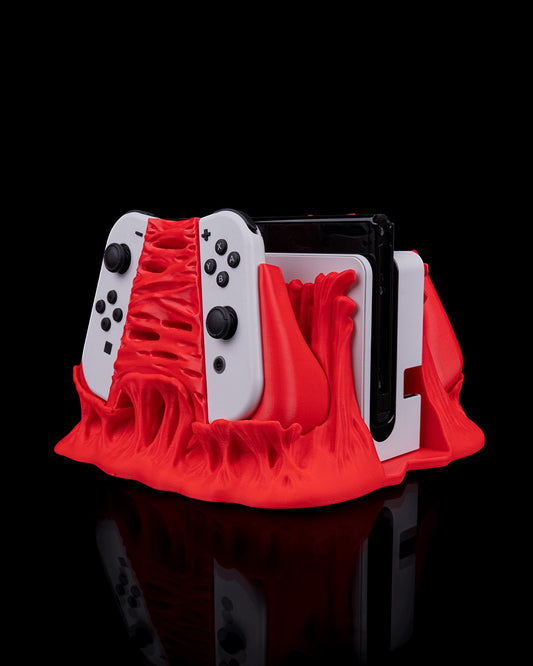 MJR Crafted red monster 3D-printed dock cover and controller holder for Nintendo Switch/OLED.